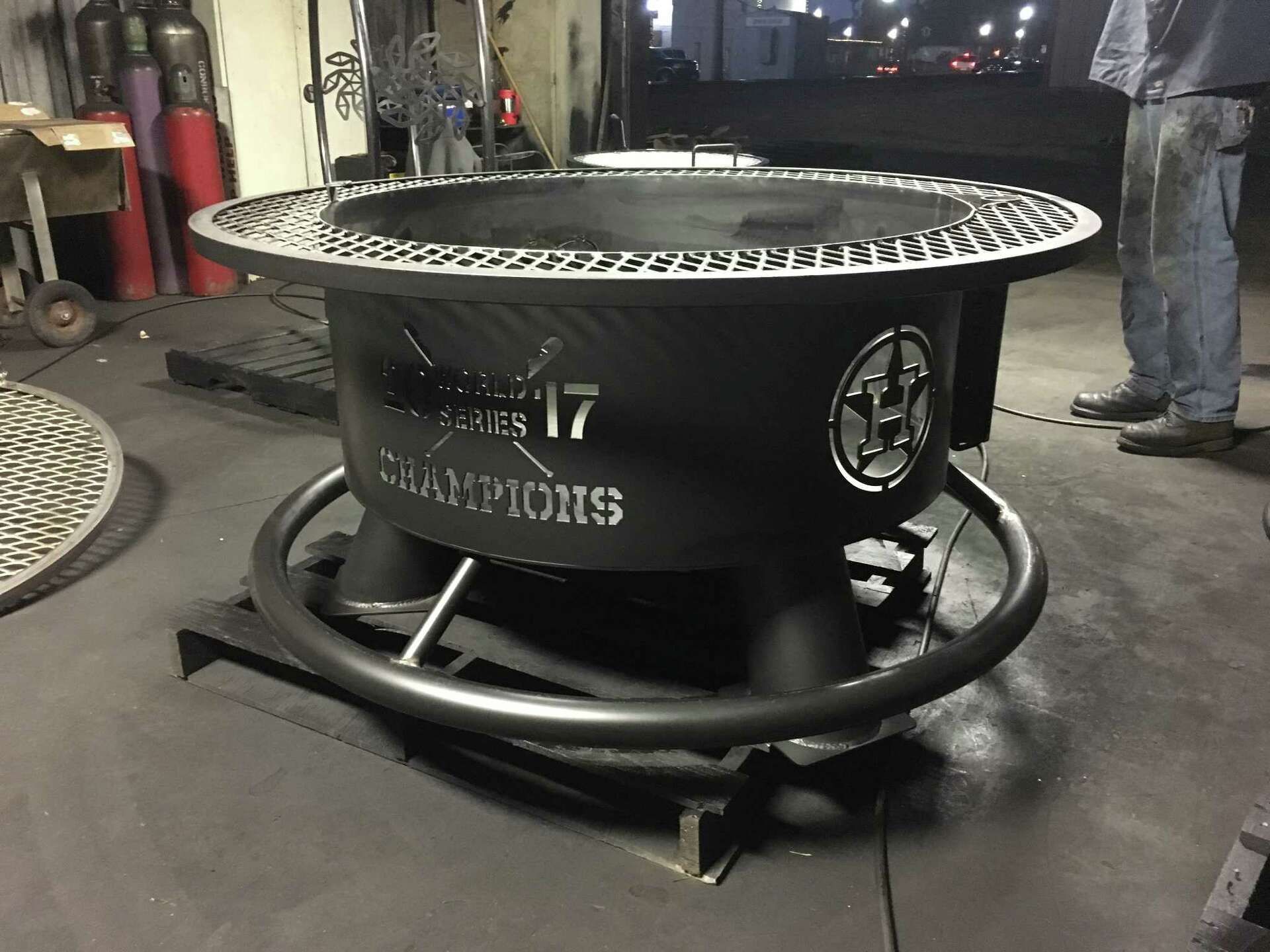 A fire pit with the word champions on it