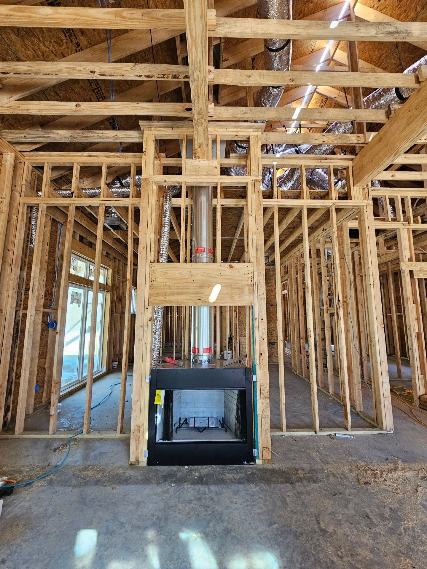 A fireplace is built into the ceiling of a house under construction.