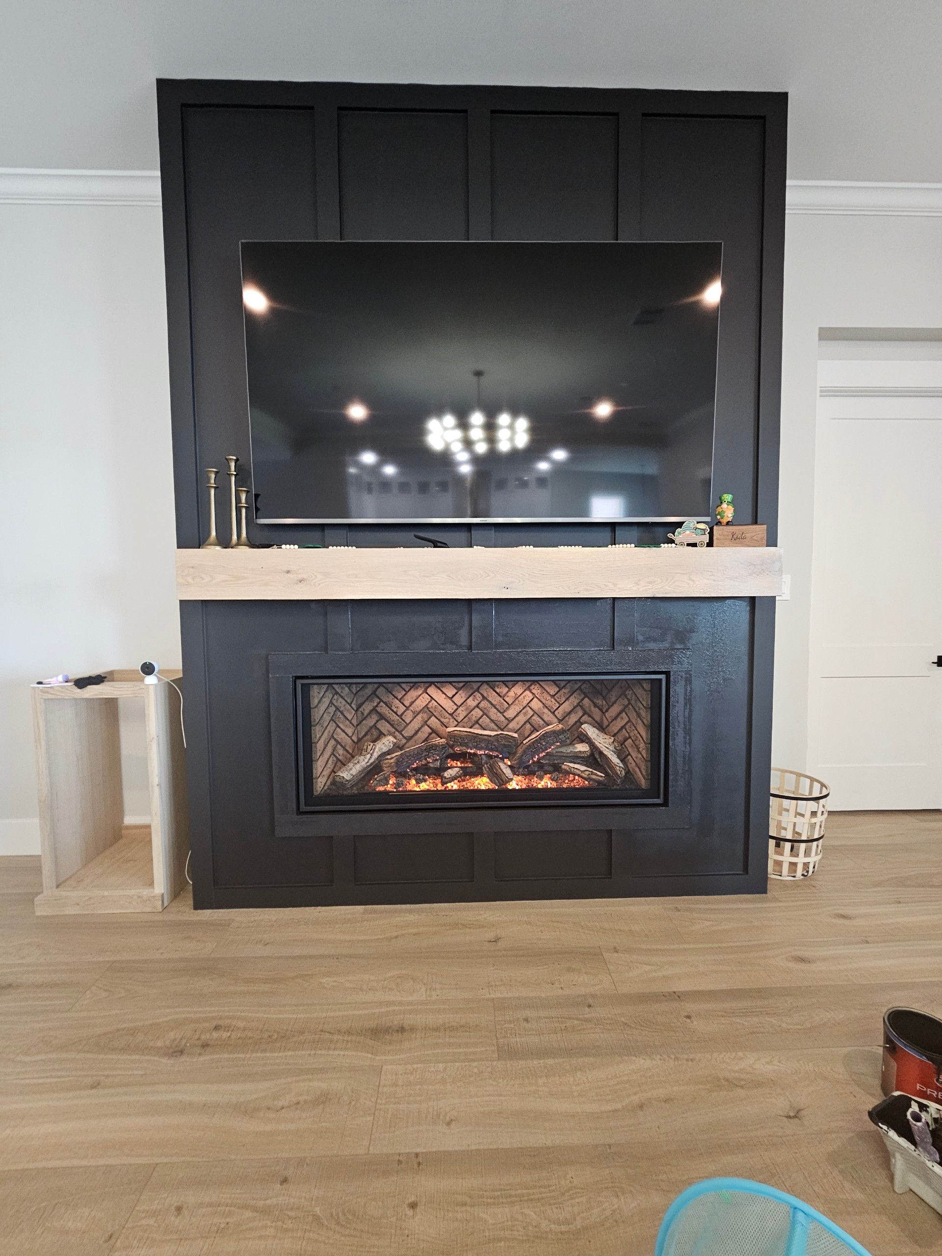 A living room with a fireplace and a flat screen tv above it.