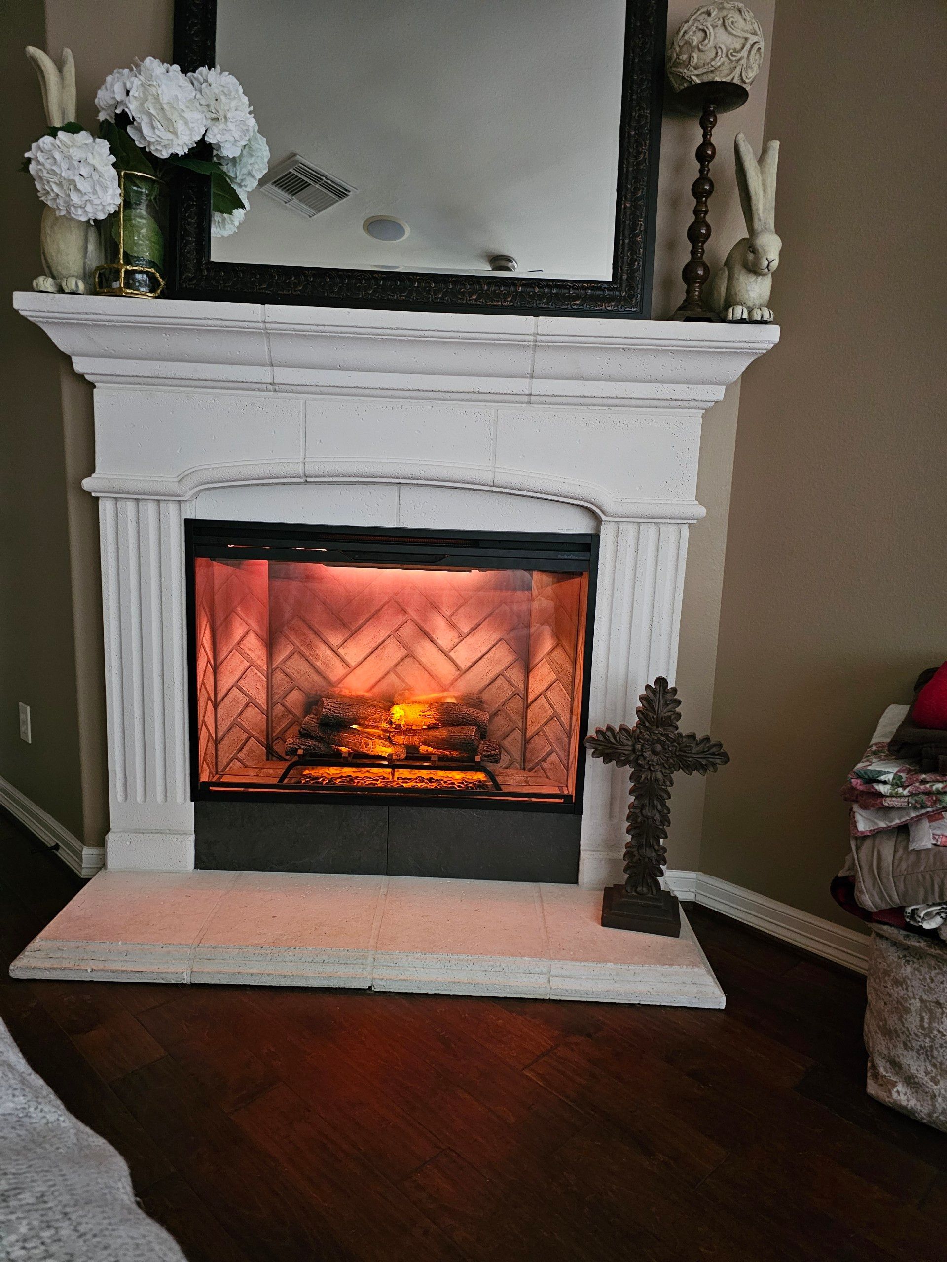 A living room with a fireplace and a mirror