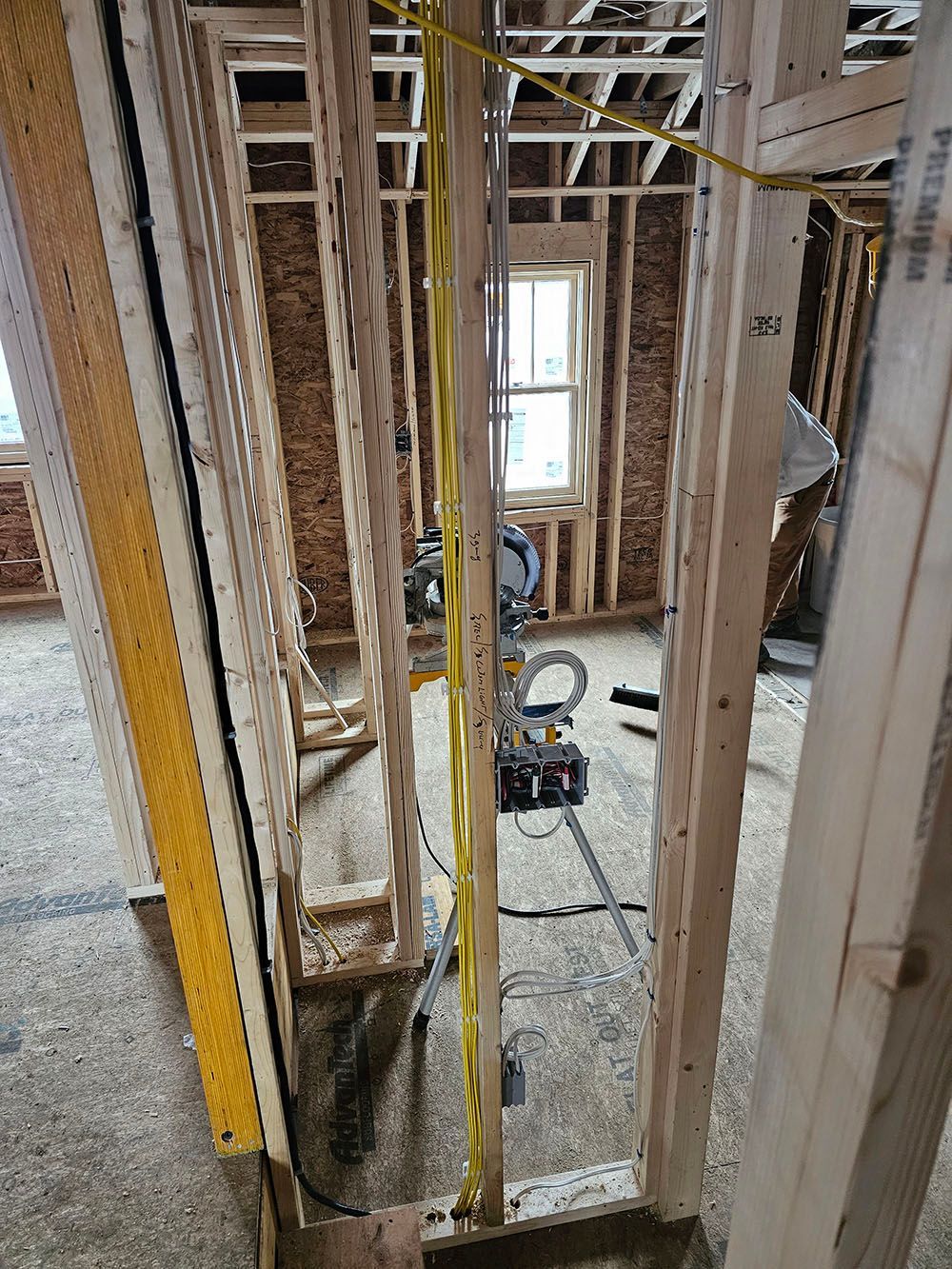 A room is being built with wooden beams and electrical wires.