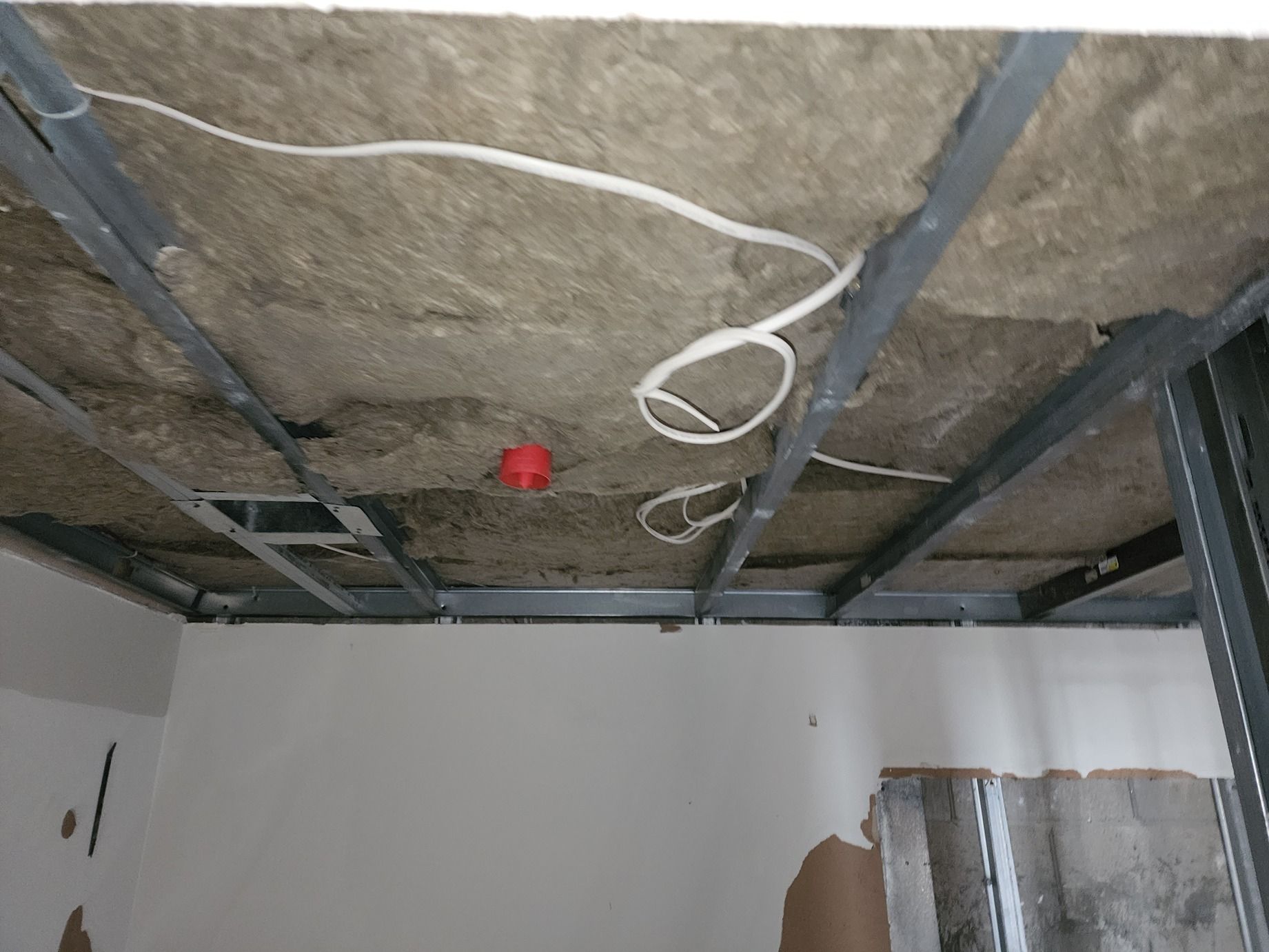 A room with a ceiling that has a red light on it.