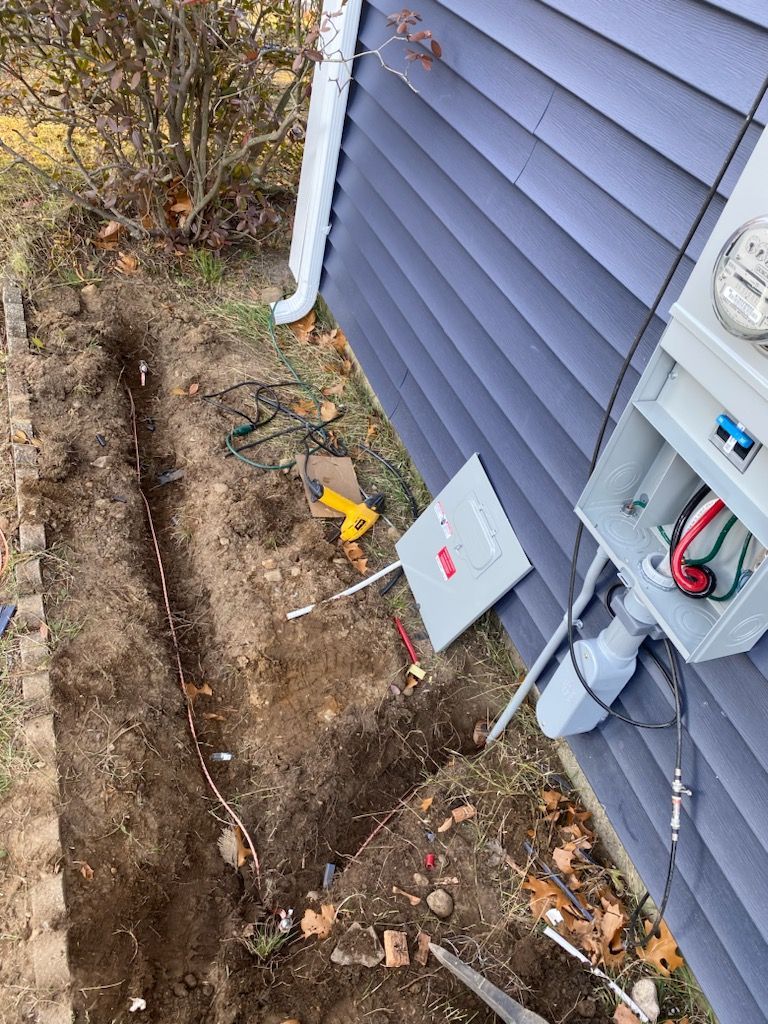 A meter is being installed on the side of a house.