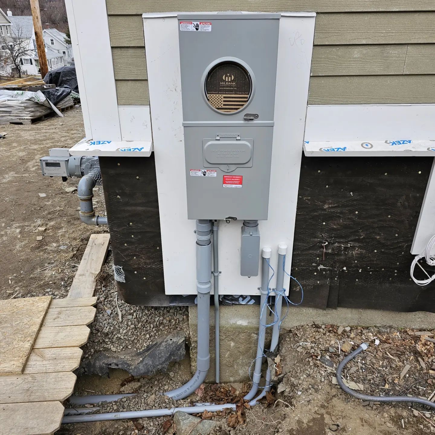 An electrical box with a round window on the side of a building