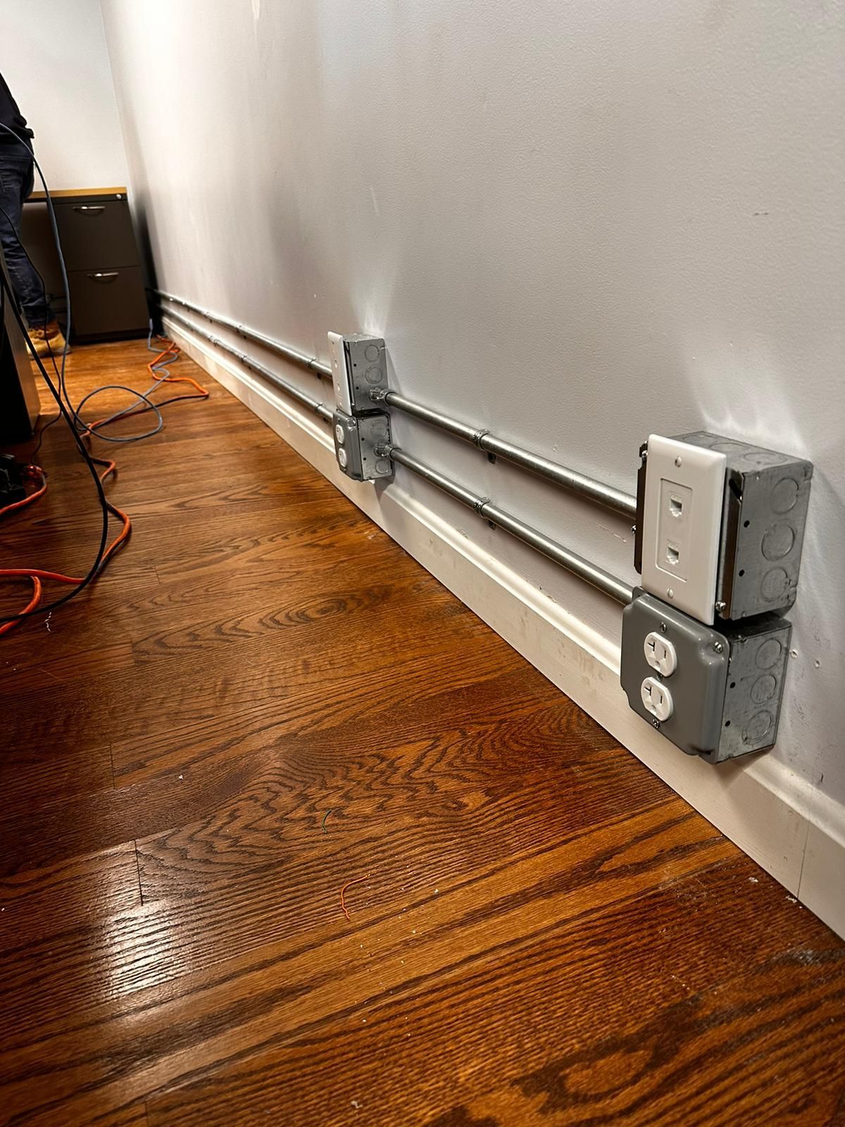 There are a lot of electrical outlets on the wall.