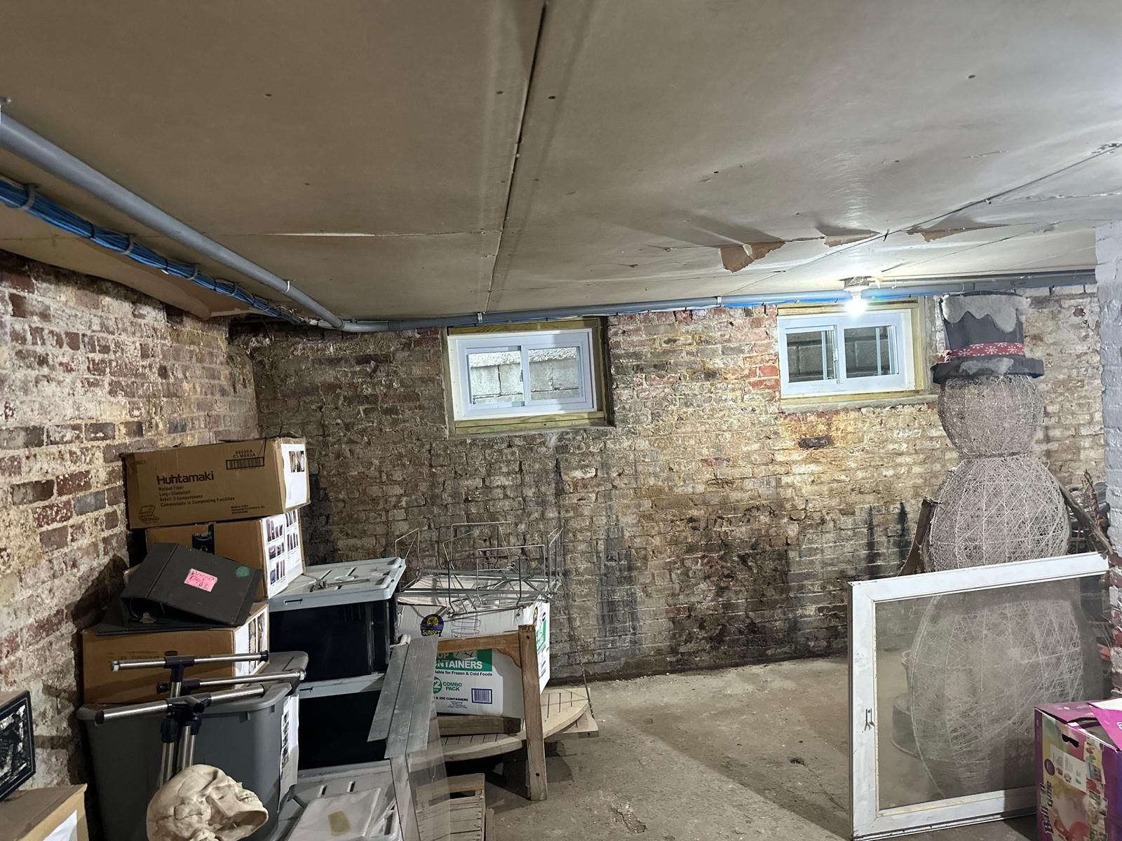 A basement filled with boxes and a window.