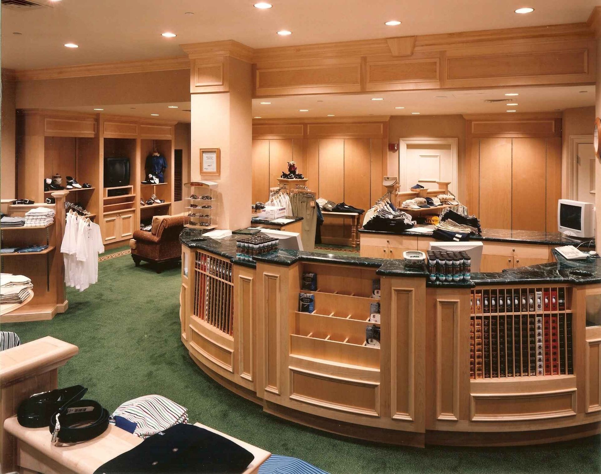 Buffet-style restaurant interior with wooden counters, trays of food, and green carpeted floor.