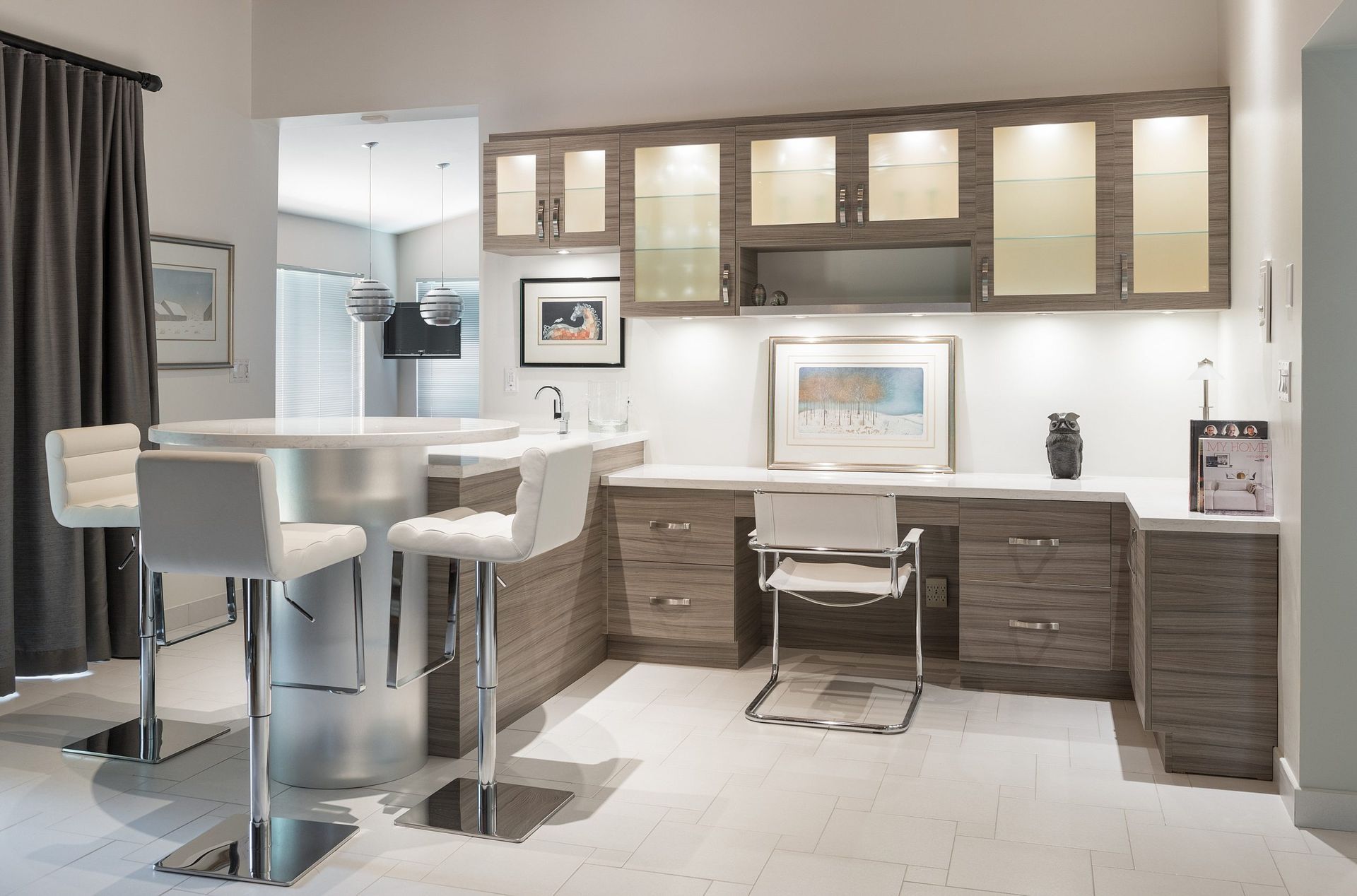Modern office with white chairs, wood desks, cabinets, and bright overhead lighting