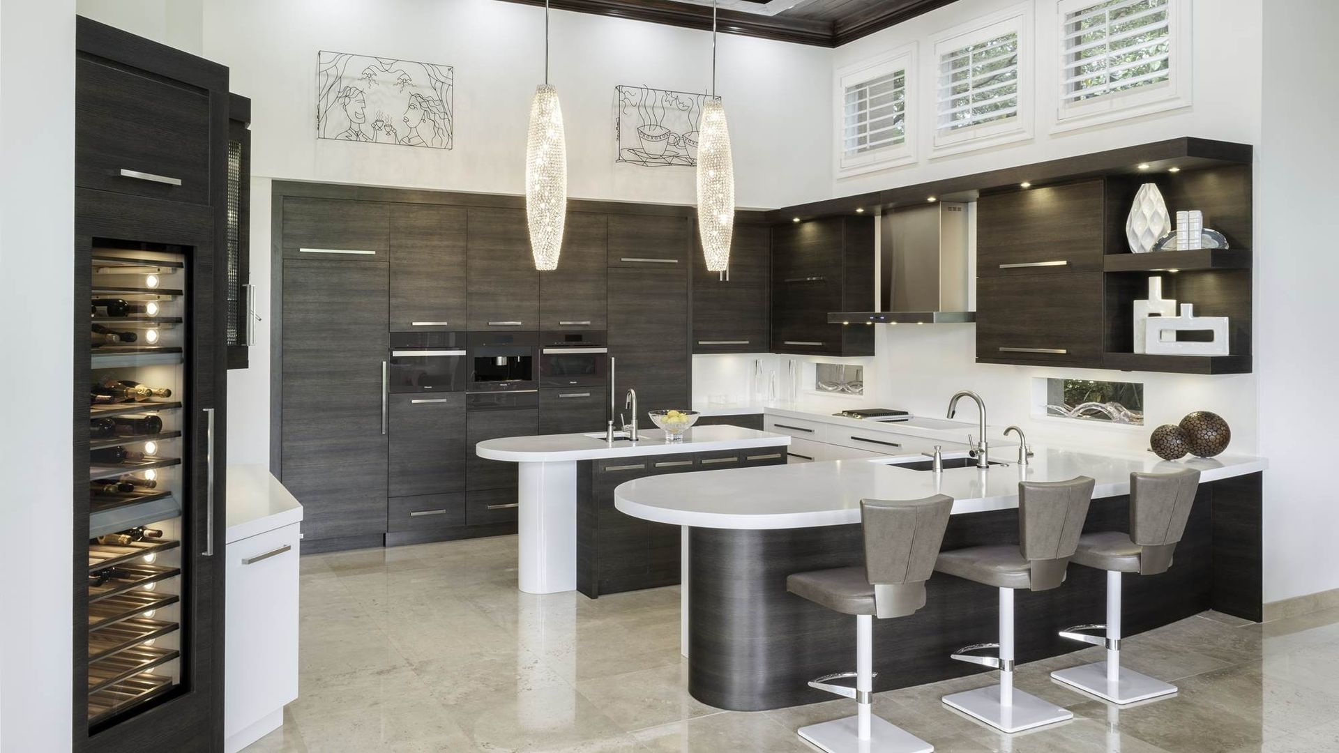 Modern black-and-white kitchen with island, bar stools, pendant lights, and built-in wine cooler