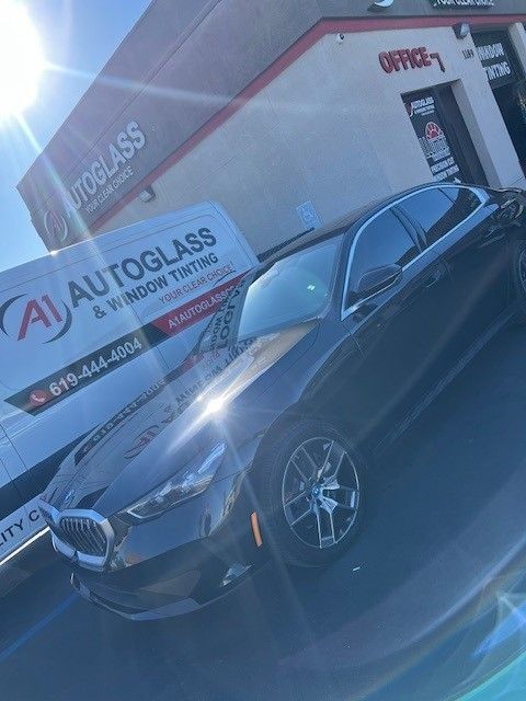 Black car with tinted windows parked near