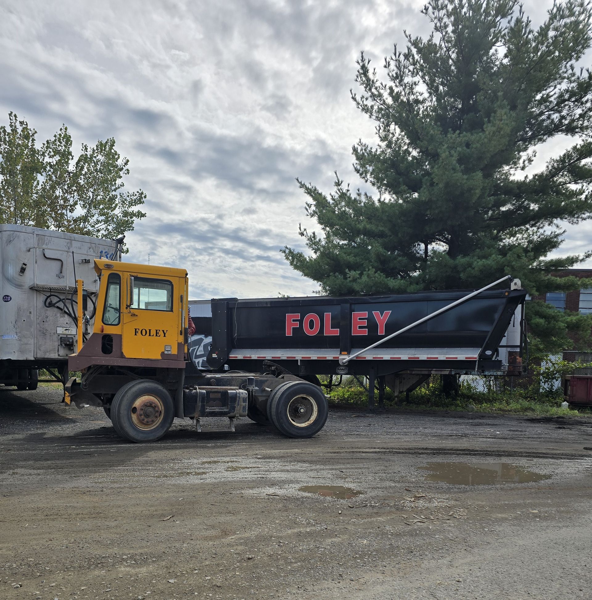 A yellow truck with the word fol ey on the side