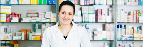 Female pharmacist in a background of medicine products