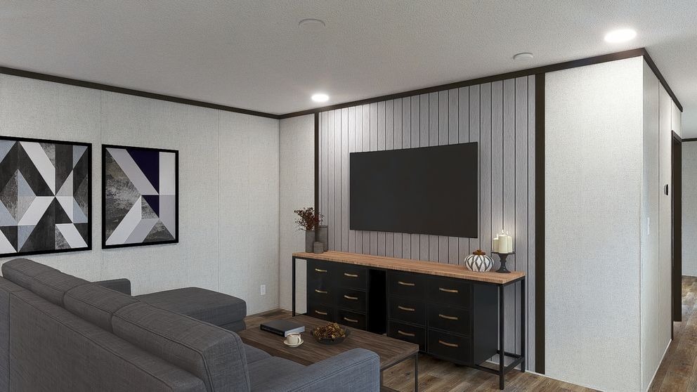 Modern living room with gray sofa, geometric wall art, TV, and console against a striped accent wall.