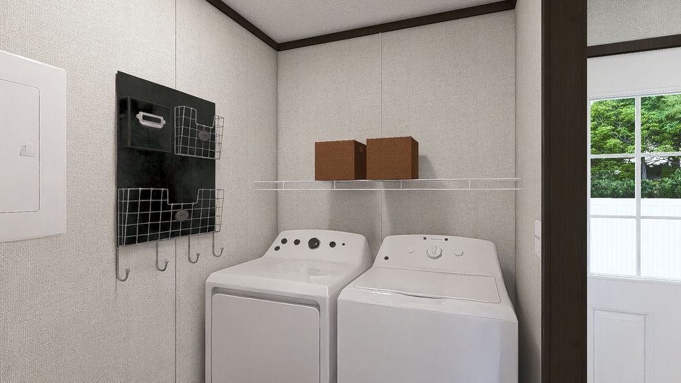 Laundry room with a white washer and dryer, wall shelf, and hanging hooks