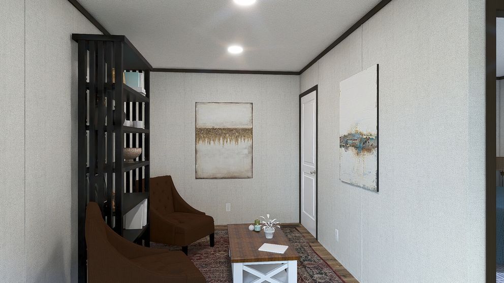 Modern living room with brown chairs, patterned rug, white walls, and framed wall art