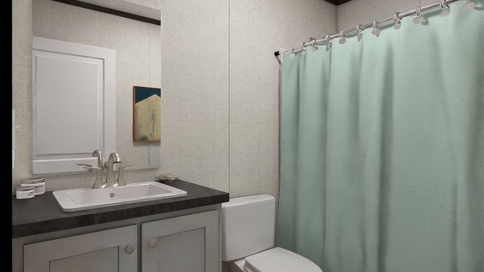 Small bathroom with white vanity, sink, toilet, mirror, and mint shower curtain.