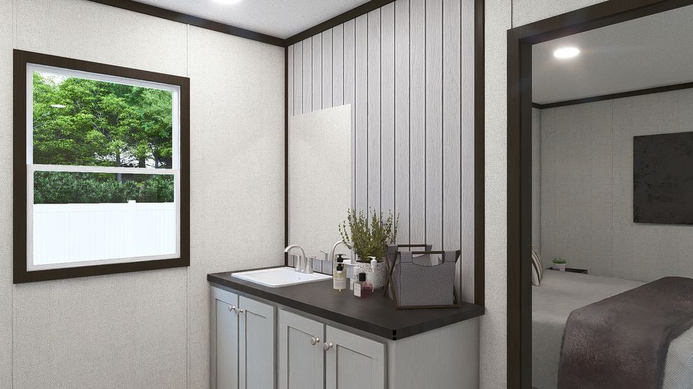 Modern bedroom with a window, vanity counter, and open doorway to a bed