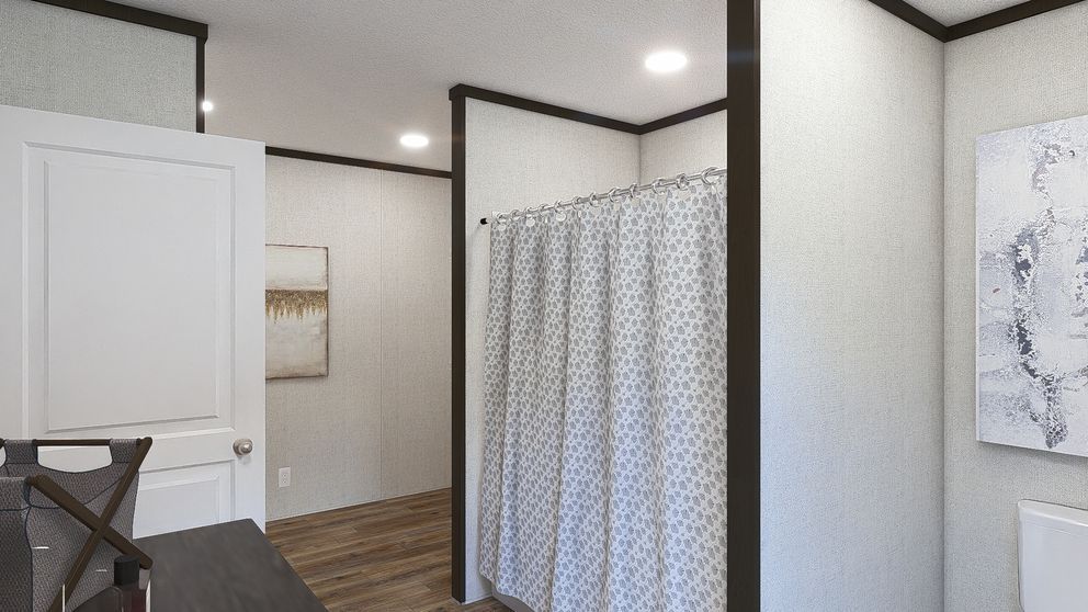 Bright clinic room with white walls, gray curtain divider, wood floor, and exam table corner