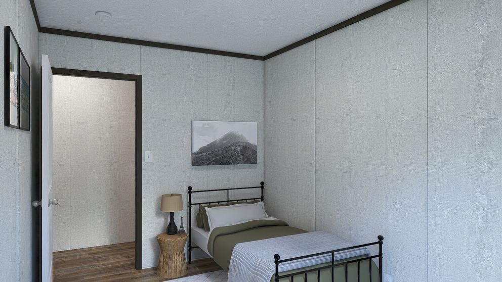 Small bedroom with two single beds, light walls, a framed landscape, and an open door.