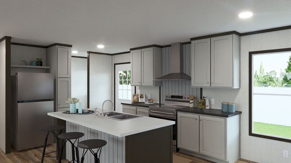 Bright modern kitchen with gray cabinets, white island, bar stools, and large windows.