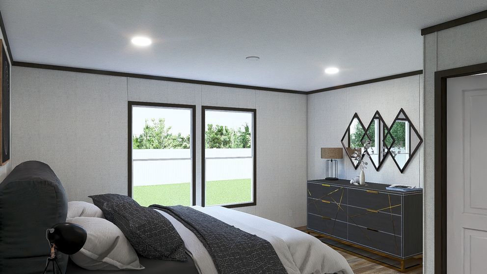 Modern bedroom with gray walls, black bed, dresser, mirrored decor, and sliding glass doors