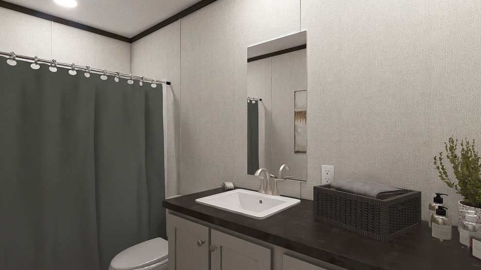 Bathroom vanity with mirror, sink, gray shower curtain, and countertop basket under soft lighting