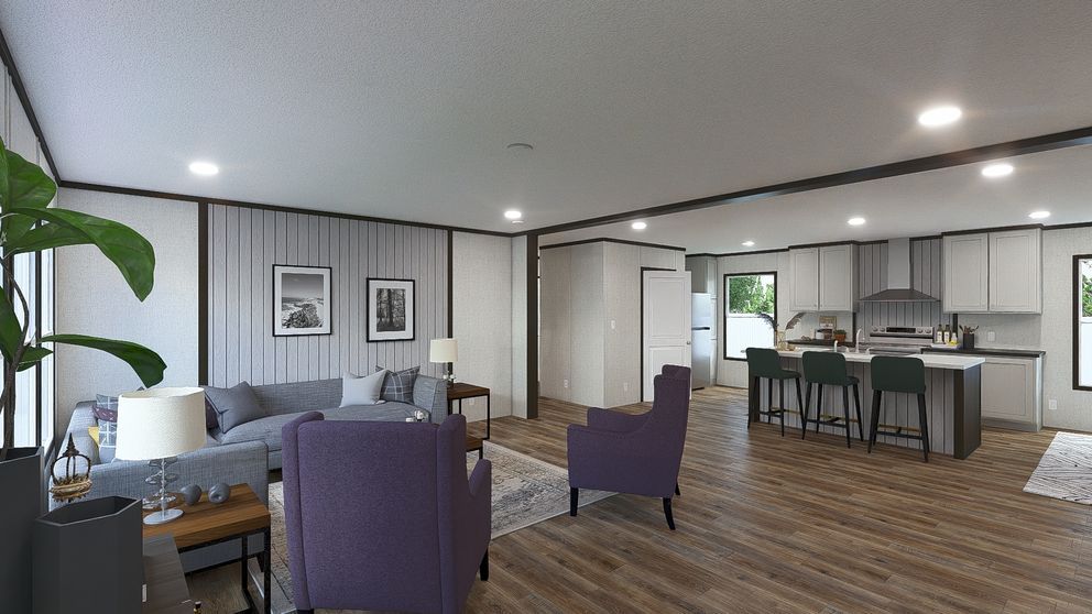 Modern open-plan living room and kitchen with gray seating, purple chairs, and wood floors