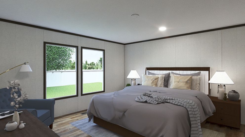Modern bedroom with a bed, lamps, and large windows overlooking a green yard