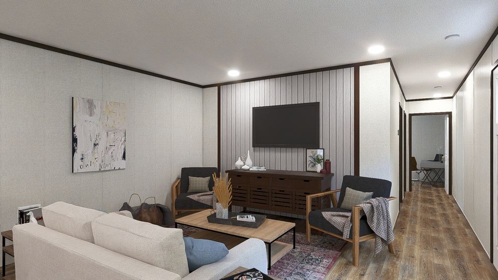 Modern living room with beige sofa, TV, desk, and hallway on the right