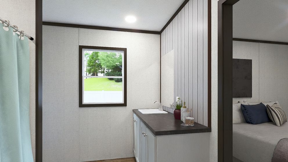 Small bedroom with a window, dresser, and a partial view of a bed behind a partition.