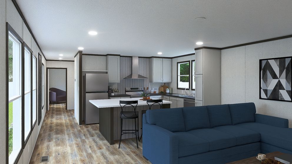 Modern open-plan living room and kitchen with blue sofa, island, and large windows