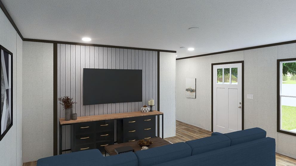 Modern living room with blue sofa, wall-mounted TV, dark console, and front door.