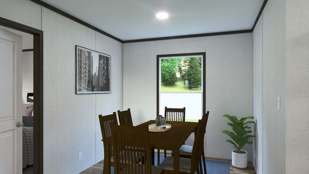 Small dining room with wooden table and chairs, wall art, and a potted plant by the open doorway.