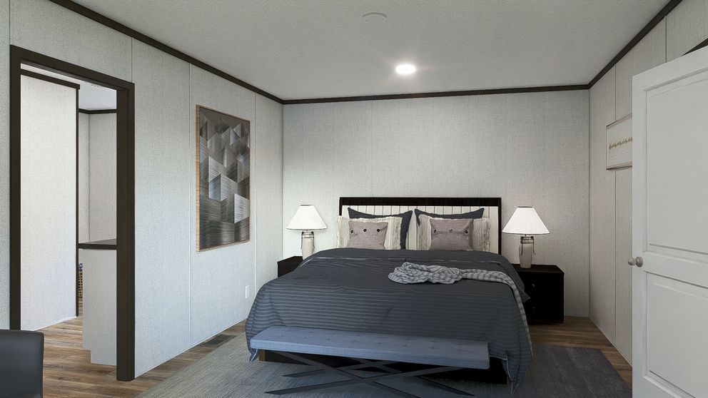 Minimal bedroom with a made bed, nightstands, lamps, and an open doorway to a bathroom