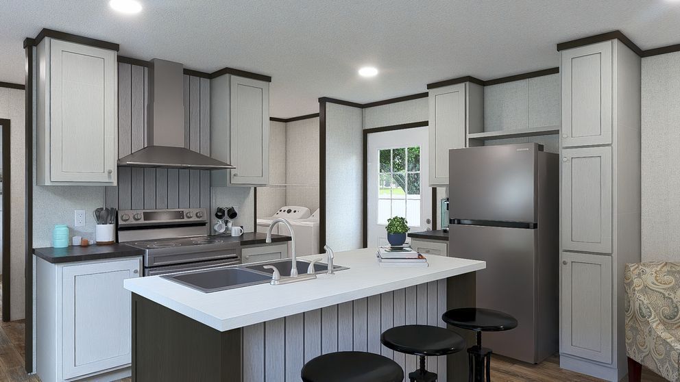 Modern kitchen with gray cabinets, white island, stainless steel appliances, and bar stools