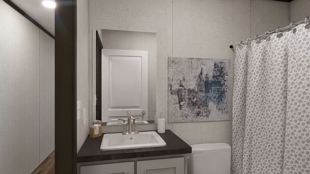 Modern bathroom vanity with mirror, sink, gray walls, abstract art, and white shower curtain