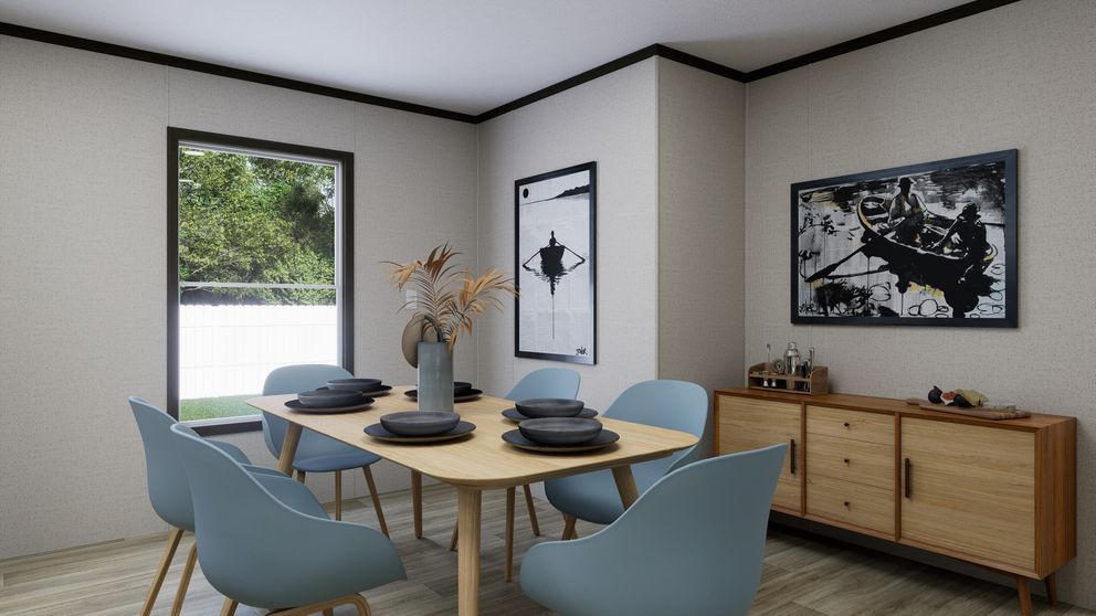 Modern dining room with round wood table, blue chairs, sideboard, and framed wall art