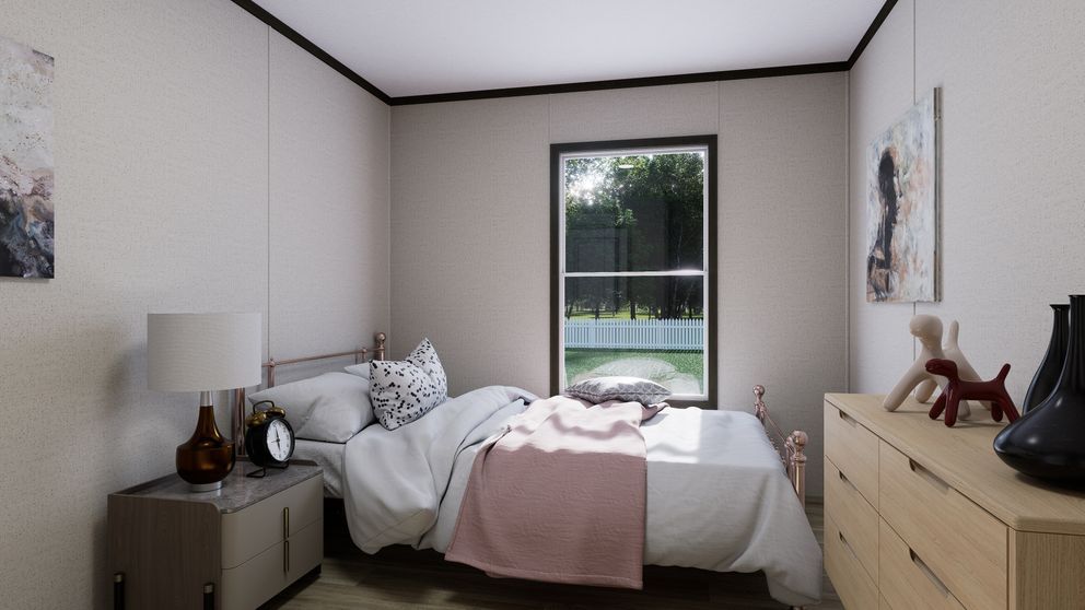 Small bedroom with a bed, nightstands, lamp, dresser, and a window view of a fenced yard.