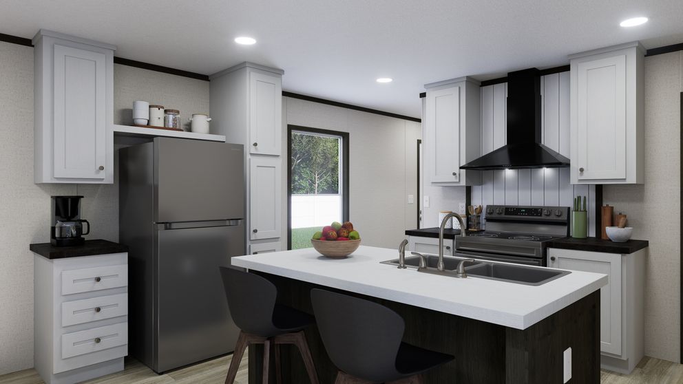 Modern kitchen with gray cabinets, black island, stainless appliances, and a bowl of fruit on the counter