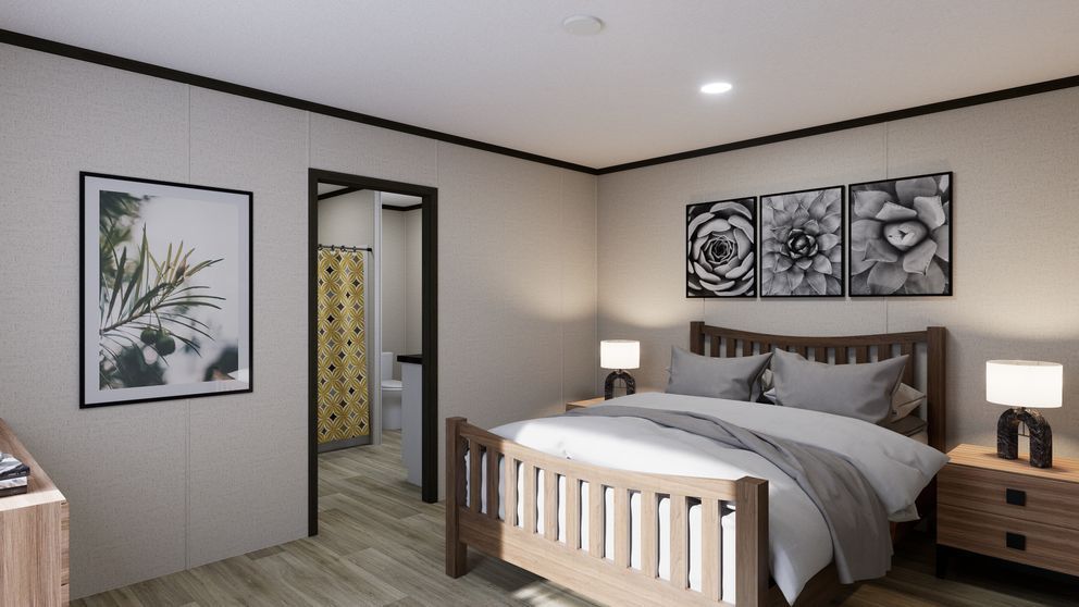Modern bedroom with a bed, nightstands, lamps, wall art, and an open doorway to a bathroom.