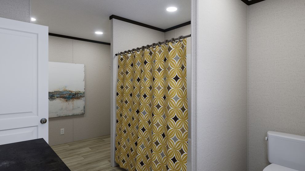 Bathroom with yellow patterned shower curtain, white door, and framed wall art in a modern interior