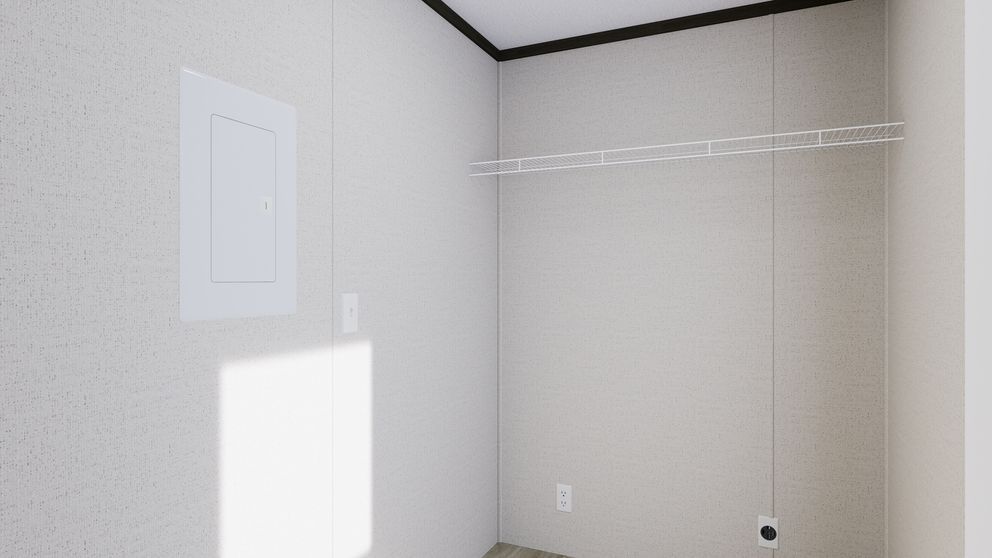 Empty beige closet with white walls, a hanging rod, and bright sunlight on the left wall