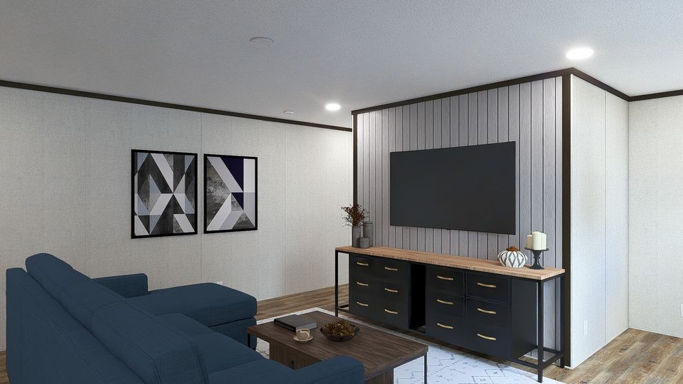 Modern living room with blue sofa, coffee table, TV, and black console against a striped accent wall