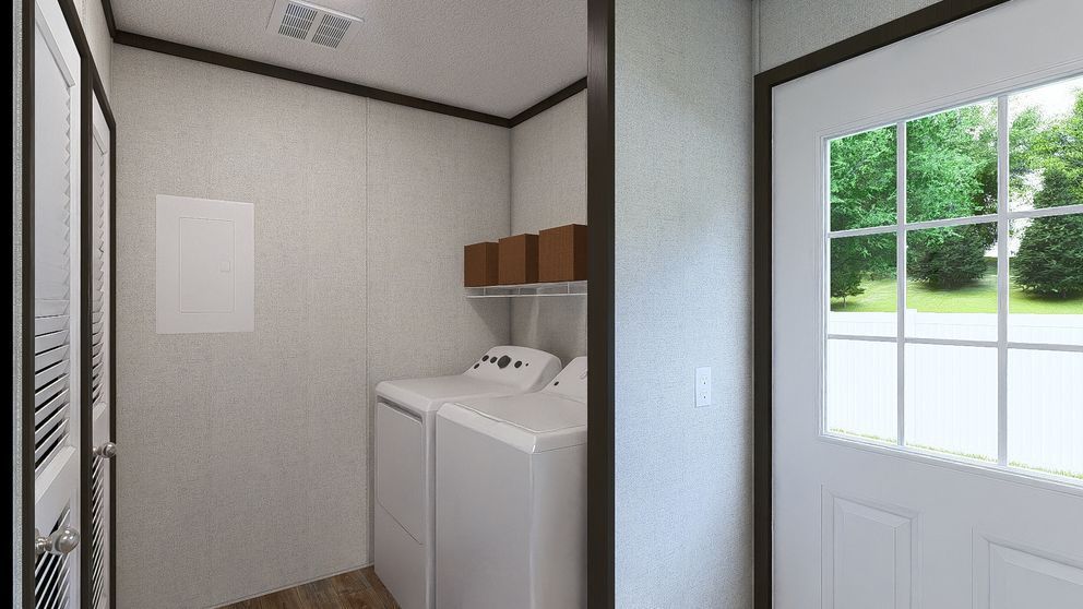 Small laundry room with stacked washer and dryer beside a white door with window.