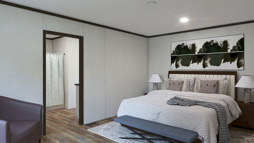 Modern bedroom with a bed, wall art, and an open doorway to a bathroom