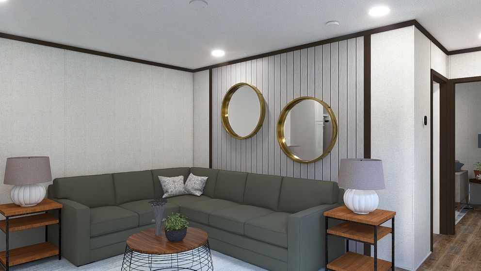 Modern living room with gray sectional sofa, round mirrors, side tables, and recessed lighting.