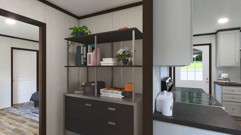 Modern kitchen with black shelving, white cabinets, coffee maker, and a bedroom visible through the doorway
