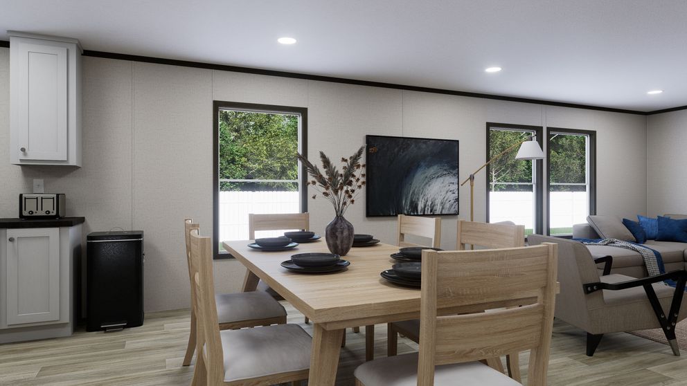 Modern open-plan dining and living room with wooden table, chairs, sofa, and large windows.