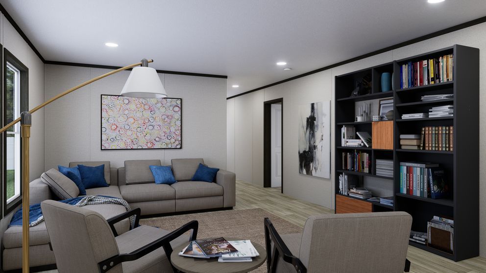 Modern living room with gray sectional, armchairs, round coffee table, bookshelf, and wall art under recessed lights