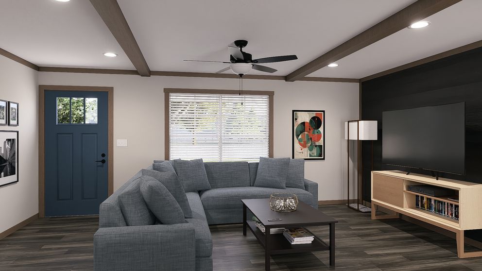 Modern living room with blue sectional sofa, TV, coffee table, and blue front door